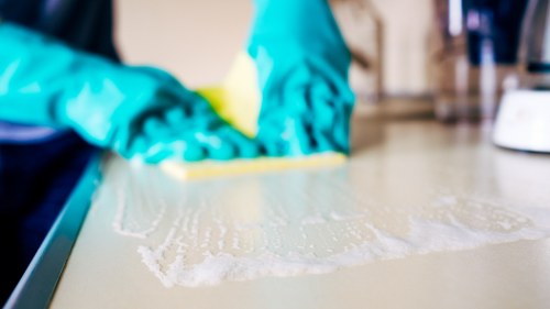Preparing a sofa for cleaning with vacuum and tools